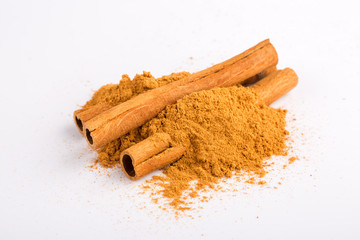 Cinnamon sticks and powder on white background