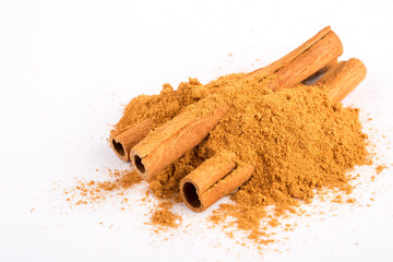 Cinnamon sticks and powder on white background