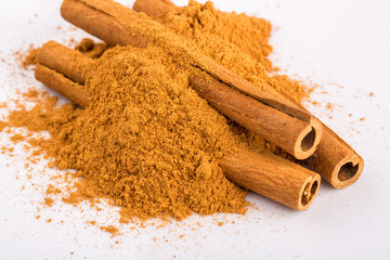Cinnamon sticks and powder on white background