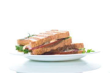 fresh sandwich with vegetables, bacon and cheese on a white