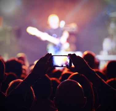 smart phone on the hand during a live concert