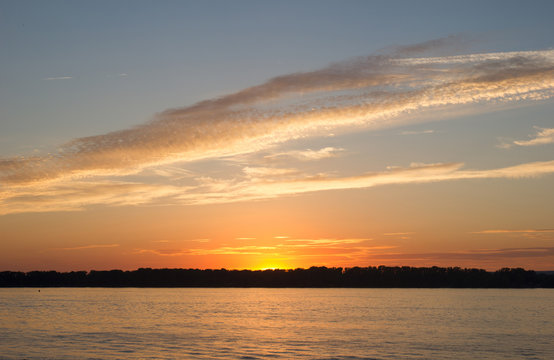 Sunset sky over the blackened forest and the river Volga opposite the city of Samara, Russia
