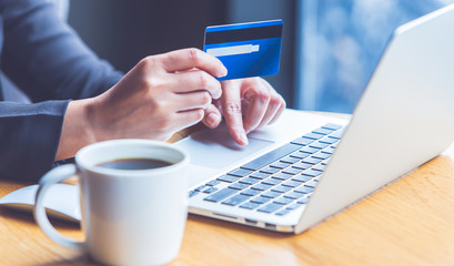 Young women who are using credit cards to order products online
