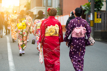 Japanese women are wearing Kimono dress and walking on the street in Kyoto.