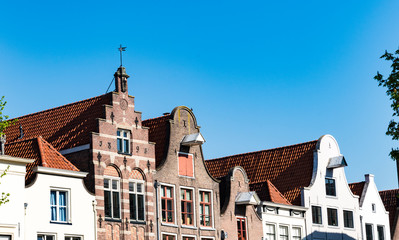 Obraz premium row gable houses in street called Nieuwe Markt in Deventer, The Netherlands. Blue sky