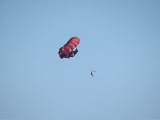 red parachuter on the sky