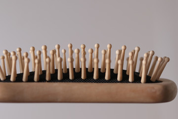 wooden hairbrush closeup on a light background