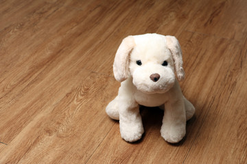 plush toy dog on the wooden floor