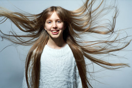 Teen Girl With Long Hair Flying In Air