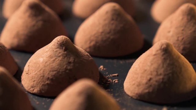 Belgian chocolate truffles on round display in slow movement