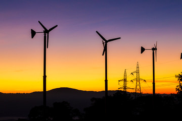 Obraz premium Future of Renewable Energy. Wind Turbines High Voltage Plantation at Sunset