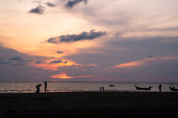 Background sky sunset,Silhouette Thai boat love travel to the beach adventure,Bright in Phuket Thailand.