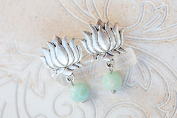 silver earrings in shape of lotus blossom and mineral avanturine gemstone