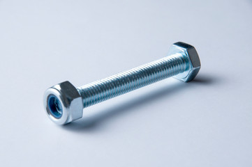 Metal bolt and nuts isolated on white background