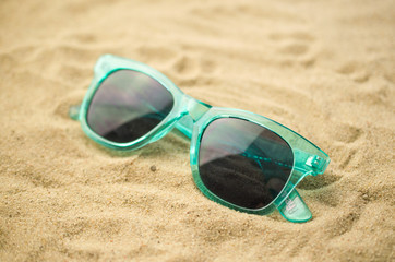 Sunglasses on beach background, summer