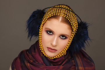 Creative portrait of an interesting woman in an unusual style using chaplet. Studio photo session