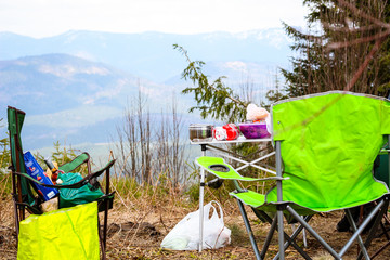 Picnic in the mountains. Folding chairs. Offroad on the Jeep in the Carpathian Mountains
