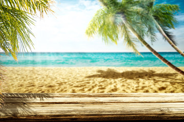 Summer landscape of beach ocean and palms. Wooden old table of free space for your decoration. 