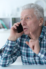 Close up portrait of senior man talking on phone