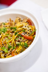Udon noodles with meat and vegetables in an Asian style