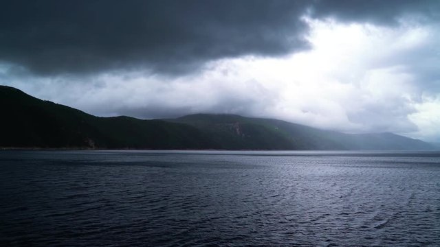 Dramatic image of agitated sea near mountain island, Croatia.