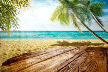 Summer landscape of beach ocean and palms. Wooden old table of free space for your decoration. 