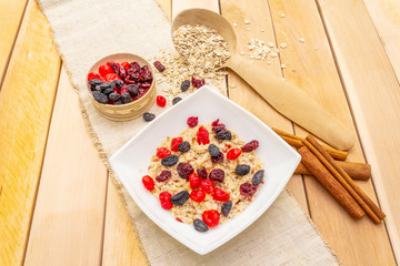 Healthy vegetarian (vegan) breakfast with oatmeal and fruits.