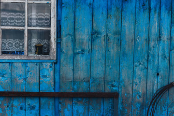 old wooden blue wall near window white frame