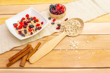 Healthy vegetarian (vegan) breakfast with oatmeal and fruits.