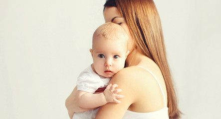 Portrait close-up baby in her mother's arms