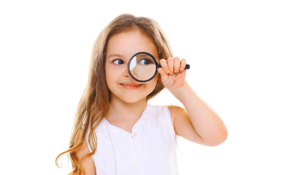 Portrait close-up little girl child looking through magnifying glass isolated on white background - Powered by Adobe