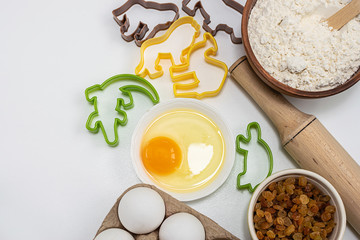 Ingredients for baking and baking forms isolated on white background top view.