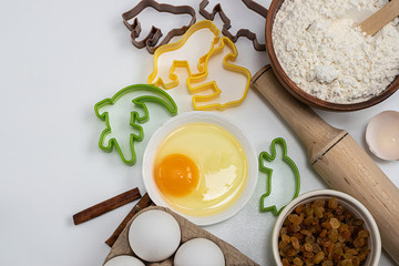 Ingredients for baking and baking forms isolated on white background top view.
