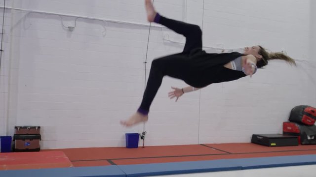 Female gymnast training in the gym for parcour and trampoline