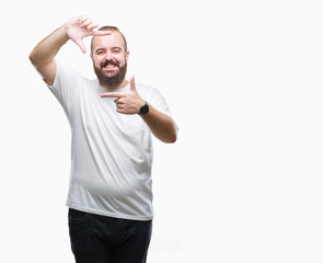Fototapeta premium Young caucasian hipster man wearing casual t-shirt over isolated background smiling making frame with hands and fingers with happy face. Creativity and photography concept.