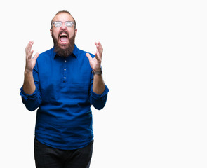 Fototapeta premium Young caucasian hipster man wearing glasses over isolated background crazy and mad shouting and yelling with aggressive expression and arms raised. Frustration concept.