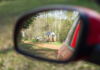 Rearview mirror with arbor in the forest. Camping concept