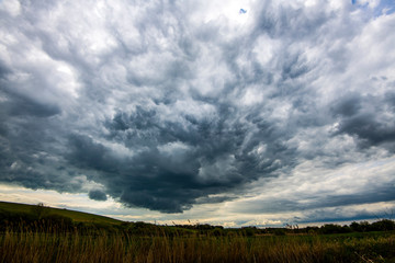 Mammatus cloud (mmatocumulus) descending from an anvil storm cloud over Combe Valley, Bexhill, East...