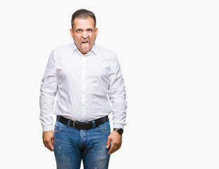 Middle age arab elegant man over isolated background sticking tongue out happy with funny expression. Emotion concept.