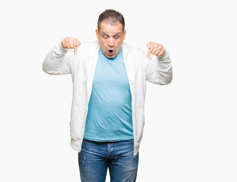 Middle age arab man wearing sweatshirt over isolated background Pointing down with fingers showing advertisement, surprised face and open mouth
