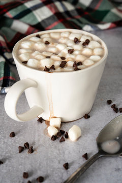 Rich hot chocolate with melting marshmallows in white coffee mug