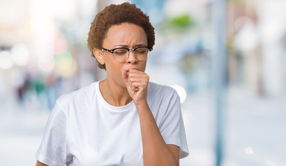 Beautiful young african american woman wearing glasses over isolated background feeling unwell and coughing as symptom for cold or bronchitis. Healthcare concept.
