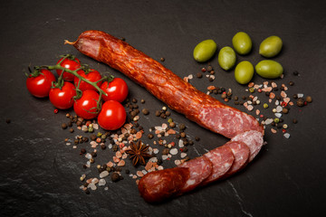 top view on long chunk of smoked sausage with sliced pieces