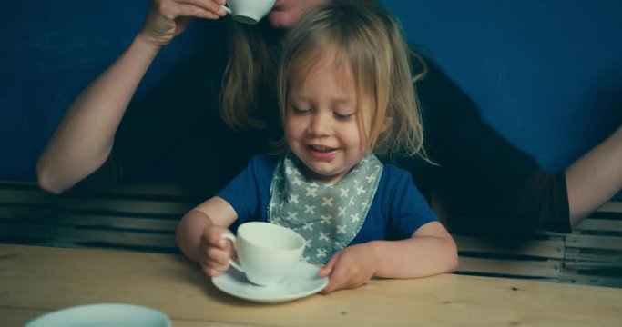 Toddler and mother drinking coffee