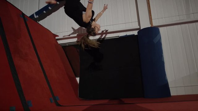 Female gymnast training in the gym for parcour and trampoline