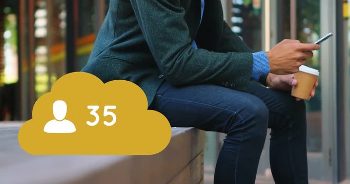 Man sitting on a brick platform checking his phone 4k