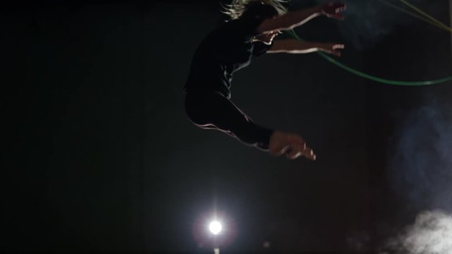 Young woman training in the gym for trampoline gymnastics and parcour