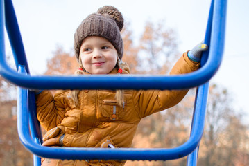Girl on the playground in the fall