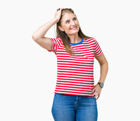 Middle age mature woman wearing casual t-shirt over isolated background Smiling confident touching hair with hand up gesture, posing attractive