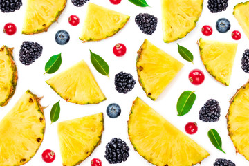 Flat lay of Sliced Pineapple, green leaves and berries isolated on white background. Fruit and Berry Pattern.